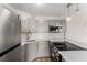 This kitchen features gray cabinets, subway tile backsplash, stainless steel appliances, and modern pendant lighting at 3315 58Th S Ave # 605, St Petersburg, FL 33712