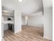 Spacious living room with wood floors adjacent to a modern kitchen and white walls at 3315 58Th S Ave # 605, St Petersburg, FL 33712