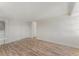 Bright living room featuring wood floors, access to multiple rooms, and white walls at 3315 58Th S Ave # 605, St Petersburg, FL 33712