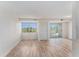 Bright living room featuring wood floors, ample natural light, and access to a private balcony at 3315 58Th S Ave # 605, St Petersburg, FL 33712