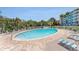 Inviting outdoor pool with surrounding lounge chairs and a well-maintained deck, ideal for relaxation at 3315 58Th S Ave # 605, St Petersburg, FL 33712