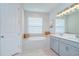 Elegant bathroom featuring a soaking tub, dual sinks, and soft lighting, creating a spa-like atmosphere at 33518 Castaway Loop, Wesley Chapel, FL 33543