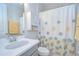 Clean bathroom with a white vanity, a toilet, and a shower with a decorative curtain at 33518 Castaway Loop, Wesley Chapel, FL 33543