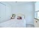 Bright bedroom with a cozy bed, closet, and a window with blinds at 33518 Castaway Loop, Wesley Chapel, FL 33543