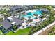 Stunning aerial view of the community pool area with lounge chairs, palm trees, and cabanas at 33518 Castaway Loop, Wesley Chapel, FL 33543