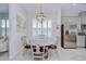 Charming dining space showcasing a modern chandelier, window shutters, and stainless steel fridge at 33518 Castaway Loop, Wesley Chapel, FL 33543