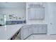 Bright kitchen boasts stainless steel appliances, light grey cabinets and bright countertops at 33518 Castaway Loop, Wesley Chapel, FL 33543