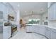 Open kitchen features stainless steel appliances, bright countertops, and a view to the living area at 33518 Castaway Loop, Wesley Chapel, FL 33543