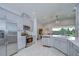 Open kitchen features stainless steel appliances, bright countertops, and a view to the living area at 33518 Castaway Loop, Wesley Chapel, FL 33543