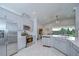 Open kitchen features stainless steel appliances, bright countertops, and a view to the living area at 33518 Castaway Loop, Wesley Chapel, FL 33543