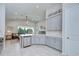 Bright kitchen boasts stainless steel appliances, light grey cabinets, and an open view to the living area at 33518 Castaway Loop, Wesley Chapel, FL 33543