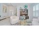 Open-concept living room features elegant furnishings, a wet bar, and large windows at 33518 Castaway Loop, Wesley Chapel, FL 33543