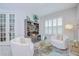 Airy living area boasts elegant furniture, plantation shutters, and a chic bar setup at 33518 Castaway Loop, Wesley Chapel, FL 33543