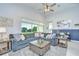 Spacious living room with modern decor, high ceilings, and a large window with a beautiful outdoor view at 33518 Castaway Loop, Wesley Chapel, FL 33543