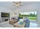 Relaxing living room with modern decor, and a large window with a beautiful outdoor view at 33518 Castaway Loop, Wesley Chapel, FL 33543