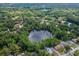 Aerial view of homes near a lake surrounded by lush greenery in a tranquil neighborhood at 3428 Valley Ranch Dr, Lutz, FL 33548