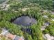Neighborhood aerial view of homes surrounding a tree-lined lake, providing a private and scenic setting at 3428 Valley Ranch Dr, Lutz, FL 33548