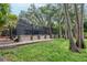 A spacious backyard with a screen-enclosed lanai and beautiful wooded views at 3428 Valley Ranch Dr, Lutz, FL 33548