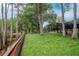 A sprawling backyard with lush greenery, mature trees, and views of the lake at 3428 Valley Ranch Dr, Lutz, FL 33548