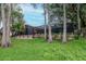 Screened-in lanai and landscaped backyard provide a private outdoor living space at 3428 Valley Ranch Dr, Lutz, FL 33548