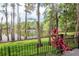 Enjoy peaceful lake views from the backyard with a black fence and lush landscaping at 3428 Valley Ranch Dr, Lutz, FL 33548