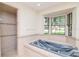 Bathroom featuring a blue soaking tub under a large window, adjacent to a shower area at 3428 Valley Ranch Dr, Lutz, FL 33548