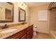 Bathroom featuring double sinks with granite counters and a window for natural light at 3428 Valley Ranch Dr, Lutz, FL 33548