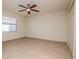 Spacious bedroom with tiled floors, a ceiling fan, and large window offering natural light at 3428 Valley Ranch Dr, Lutz, FL 33548