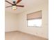 Bright bedroom with ceiling fan and large window offering natural light at 3428 Valley Ranch Dr, Lutz, FL 33548