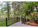 Wooden back deck overlooking landscaped yard and lake at 3428 Valley Ranch Dr, Lutz, FL 33548