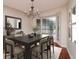 Elegant dining room featuring a chandelier, large windows, and stylish table setting at 3428 Valley Ranch Dr, Lutz, FL 33548