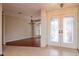 Bright foyer featuring decorative glass double doors, tile flooring, and chandelier at 3428 Valley Ranch Dr, Lutz, FL 33548