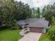 Charming home featuring a well-maintained front yard and a two-car garage at 3428 Valley Ranch Dr, Lutz, FL 33548