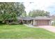 Charming single-story home featuring a well-manicured lawn and an attached two-car garage at 3428 Valley Ranch Dr, Lutz, FL 33548