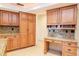 The kitchen features a built-in desk, lots of storage, and granite countertops at 3428 Valley Ranch Dr, Lutz, FL 33548
