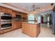 Bright, open kitchen with granite counters, stainless appliances, and a large central island at 3428 Valley Ranch Dr, Lutz, FL 33548