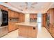 Spacious kitchen featuring a center island, granite countertops, and stainless steel appliances at 3428 Valley Ranch Dr, Lutz, FL 33548