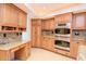 Well-lit kitchen boasts custom cabinetry, granite countertops, and stainless steel appliances at 3428 Valley Ranch Dr, Lutz, FL 33548