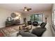 Cozy living room with a comfortable sectional sofa, ceiling fan, and view of the pool at 3428 Valley Ranch Dr, Lutz, FL 33548