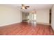 Large living room featuring hardwood floors, ceiling fan, and view into the foyer at 3428 Valley Ranch Dr, Lutz, FL 33548