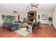 Spacious living room featuring a stone fireplace, ceiling fans, and sliding glass doors to pool at 3428 Valley Ranch Dr, Lutz, FL 33548