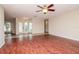 Expansive living room featuring hardwood floors, ceiling fan, and view into the foyer at 3428 Valley Ranch Dr, Lutz, FL 33548
