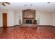 Spacious living room features a stone fireplace and rich wood-look floors, enhancing the home's cozy ambiance at 3428 Valley Ranch Dr, Lutz, FL 33548