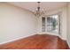 Bright, blank living room with hardwood floors, bay window, and elegant chandelier at 3428 Valley Ranch Dr, Lutz, FL 33548