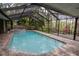Backyard pool area and jacuzzi with covered enclosure at 3428 Valley Ranch Dr, Lutz, FL 33548