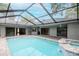 Backyard pool area with spa and covered enclosure at 3428 Valley Ranch Dr, Lutz, FL 33548