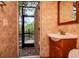 Powder room with modern vanity and view of the outdoor deck and water at 3428 Valley Ranch Dr, Lutz, FL 33548