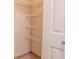 Walk-in closet featuring wire shelving and ample storage space behind a white paneled door at 3428 Valley Ranch Dr, Lutz, FL 33548