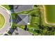 Aerial view of a home featuring a well-manicured lawn and a beautiful backyard pond at 34307 Radley Way, Wesley Chapel, FL 33545