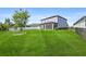 Wide backyard with a screened-in patio, expansive lawn and a sleek black fence at 34307 Radley Way, Wesley Chapel, FL 33545